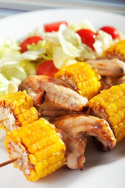 Chicken wings with corn skewers — Stock Photo, Image