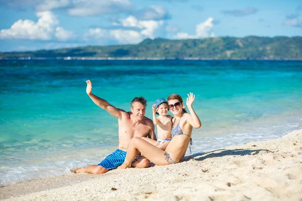 Happy family playing on beach — Stock Photo, Image