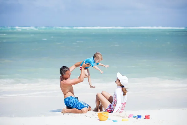 Happy family playing on beach — Stock Photo, Image