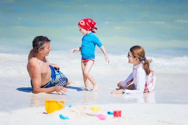 Happy family playing on beach — Stock Photo, Image