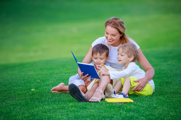 Young attractive mother reads story — Stock Photo, Image