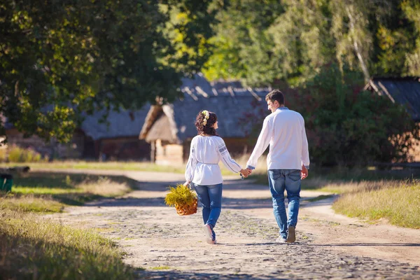 Jovem casal em estilo ucraniano roupas andando ao longo da estrada — Fotografia de Stock