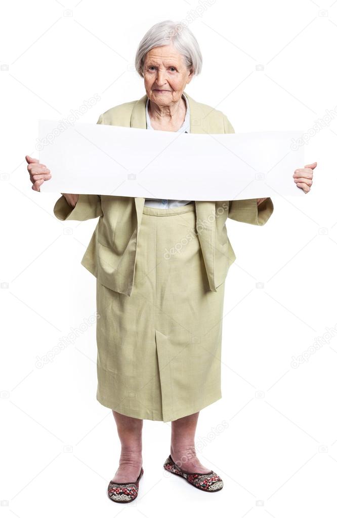 Happy elderly lady holding blank sheet in hand over white