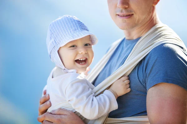 Happy toddler boy in sling, father carrying son — Stock Photo, Image