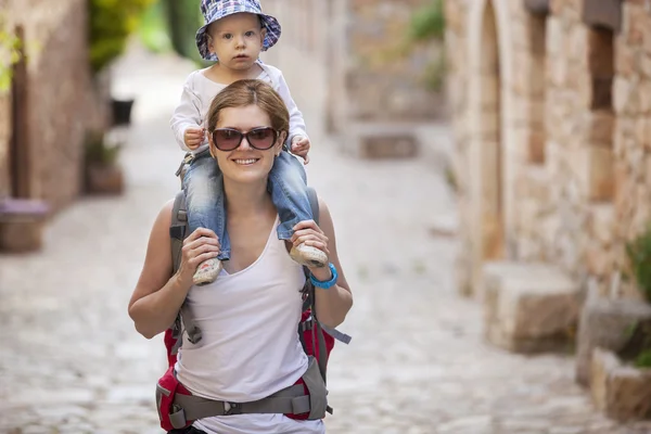 Caucasian woman tourist carrying her little son — Stock Photo, Image