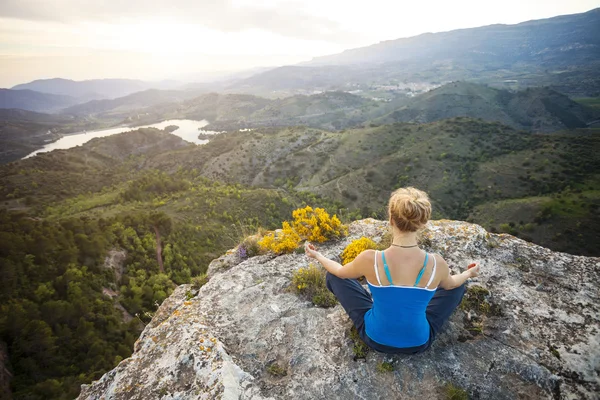 Kayanın üzerinde oturan ve Vadi Manzaralı zevk kadın — Stok fotoğraf