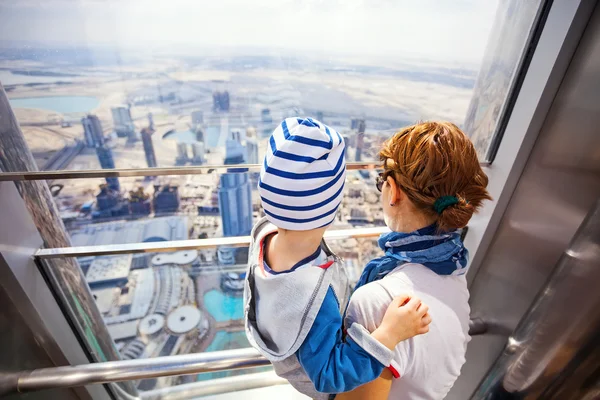 Mother and son look out of the window