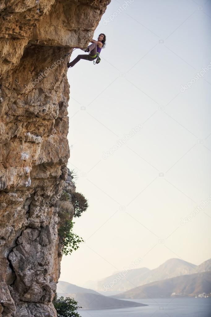 Young rock climber on a cliff