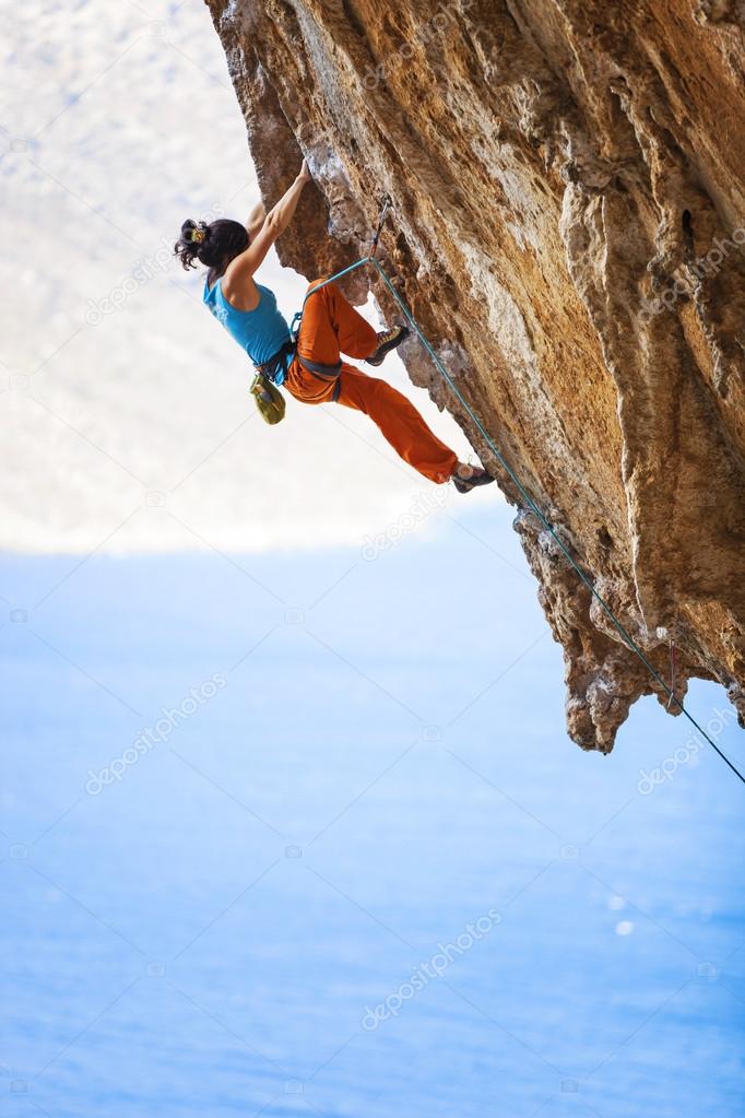 female rock climber on a cliff