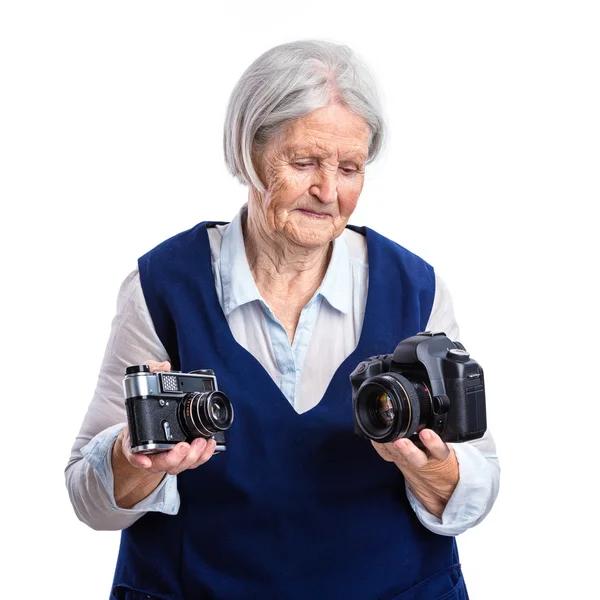 Woman choosing between old camera and modern — Stock Photo, Image