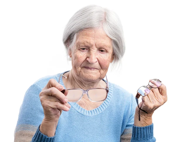 Senior woman holdig two pairs of glasses — Stock Photo, Image