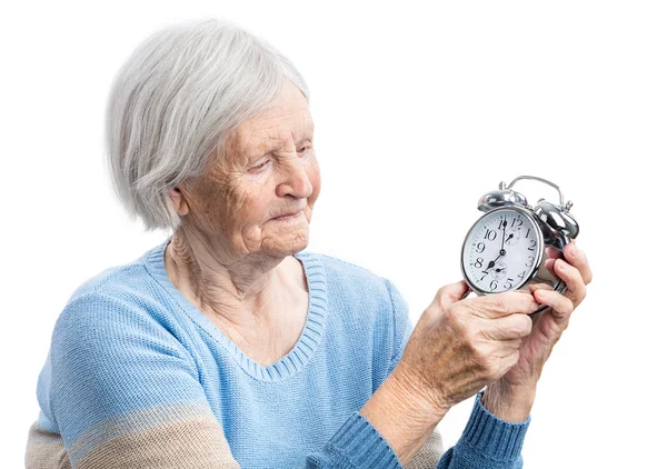 Senior woman holding a clock — Stock Photo, Image