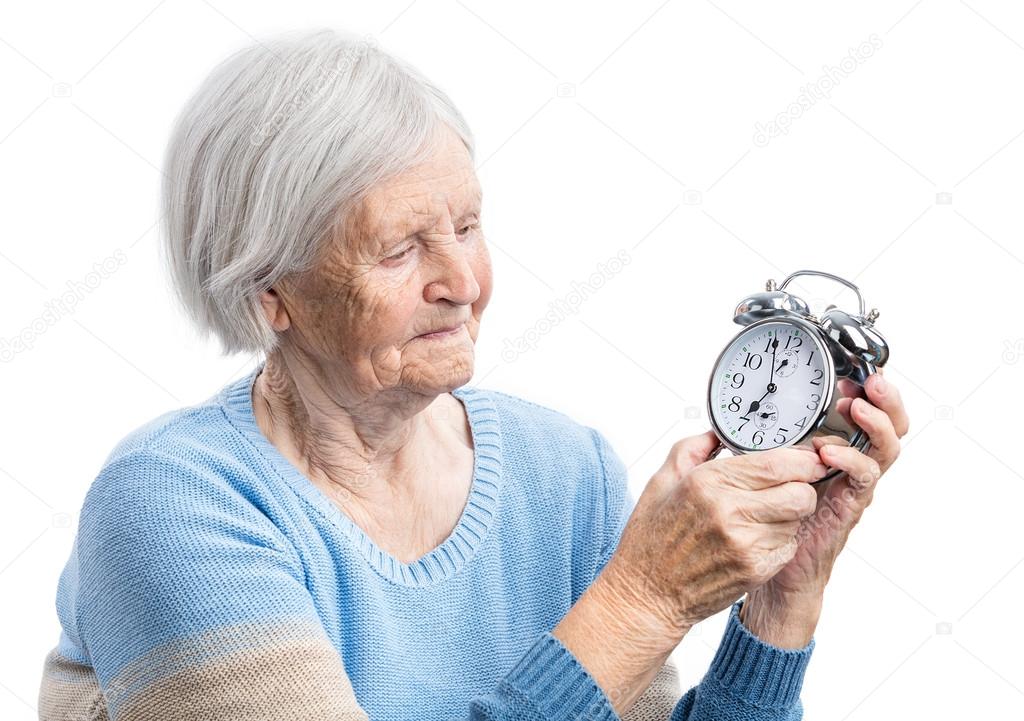 Senior woman holding a clock