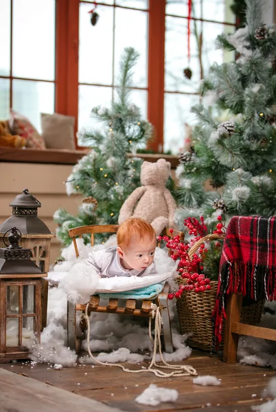 Cute baby boy lying on sled — Stock Photo, Image