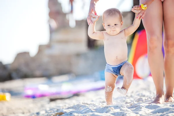 Baby boy walking along beach — Stock Photo, Image