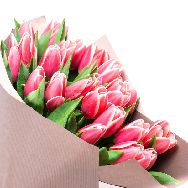 Bouquet of pink tulips in a package of kraft paper, isolated on — Stock Photo, Image