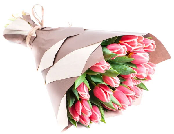 Bouquet of pink tulips in a package of kraft paper, isolated on — Stock Photo, Image