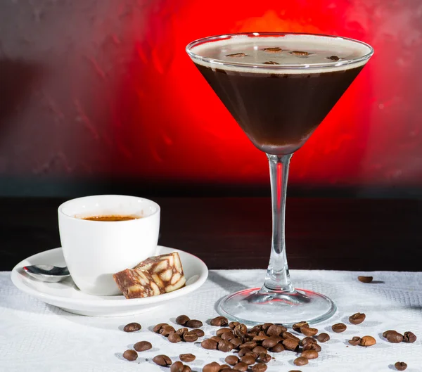 Fresh coffee cocktail with coffee beans and espresso on a color