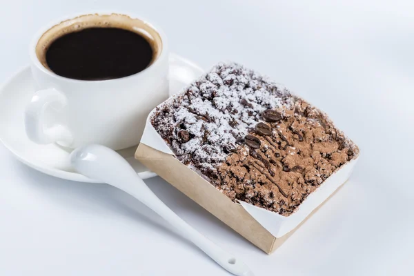 Chocolate cake with coffee beans in the background cup of coffee — Stock Photo, Image