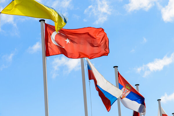 flag of Ukraine, Turkey and Russia against the blue sky