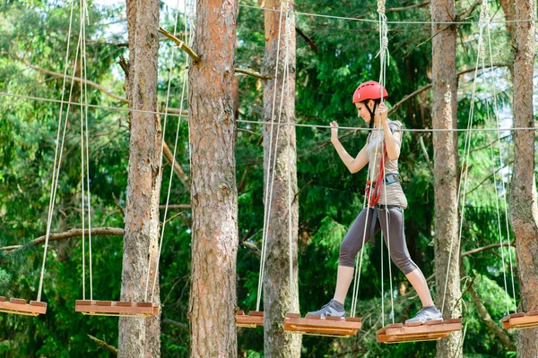 Adventure climbing high wire park - Young woman on course in mou — Stock Photo, Image