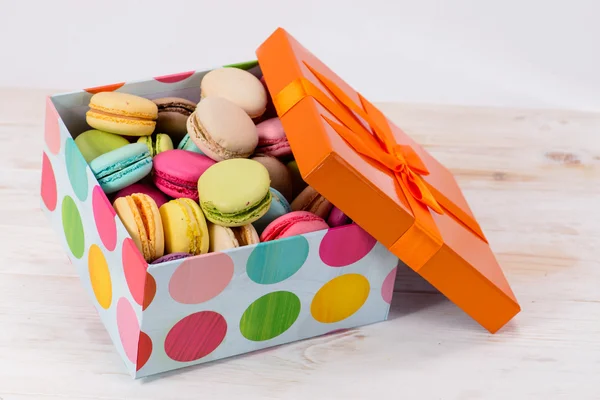 box with multicolored french macaroon . Trendy sweet colorful co