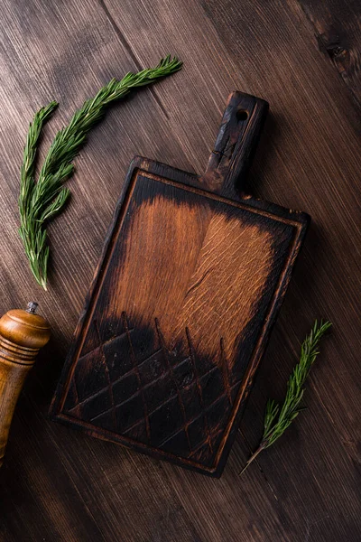 wooden cutting boards on a brown table with space for copy space.