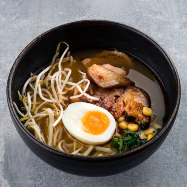 Geleneksel Japon çorbası eriştesi et suyu, Asya Udon eriştesi, deniz yosunu, koyu beton arka planda yumurta ve zencefil. Asya usulü yemek. Akşam yemeği için sıcak erişte çorbası.