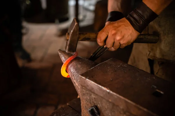 Detail shot of metal being worked at a blacksmith forge