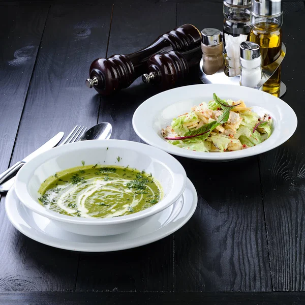Summer lunch green salad soup, served on wooden table, two course meal business lunch at restaurant