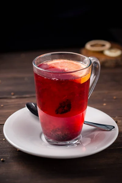 Winter fruit tea with fresh fruits, red fruit tea with orange