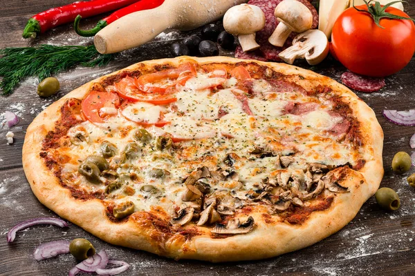 Four Season Pizza slice on wooden table, four seasons pizza with salami mushrooms and minced meat. Italian Quattro Stagioni