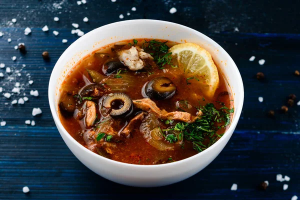 fish soup solyanka with olives and lemon, Solyanka spicy and sour soup, Russian soup with fish