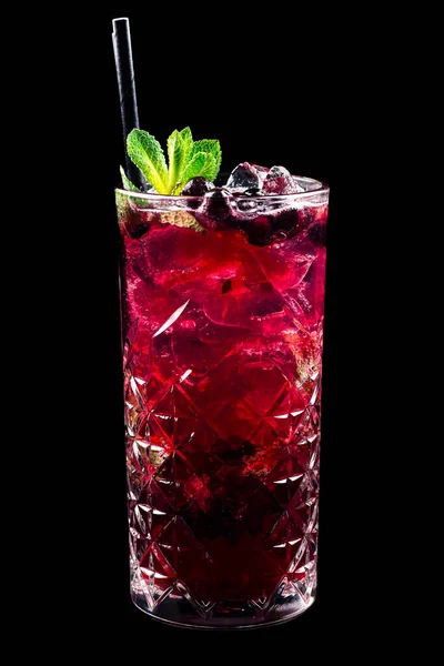 black currant lemonade with ice cubes and mint, cold summer lemonade with black currant isolated on a black background