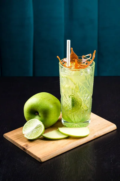 Cold summer lemonade with apple, Apple drink with ice cubes. Summer cocktail with green apple and ice. Apple cider