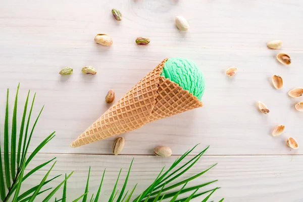 green ice cream with pistachios on a white wooden background, Pistachio ice cream close up shoot with copy space background