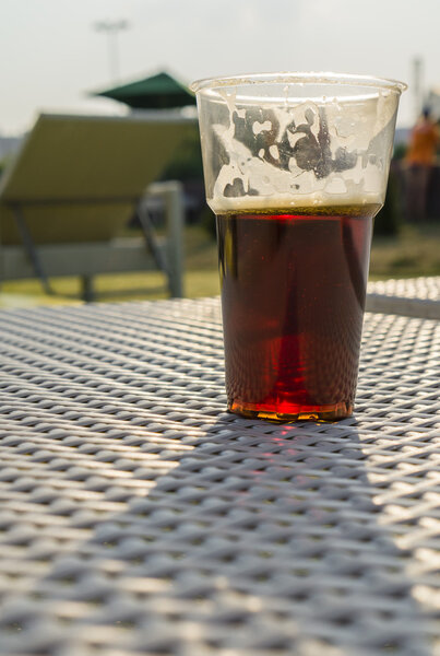 glass of beer backlit afternoon sun close-up