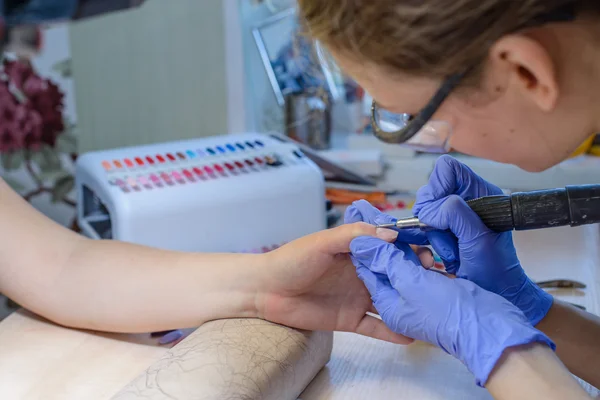 Närbild av händerna på en ung kvinna som tar emot nagelklippare — Stockfoto