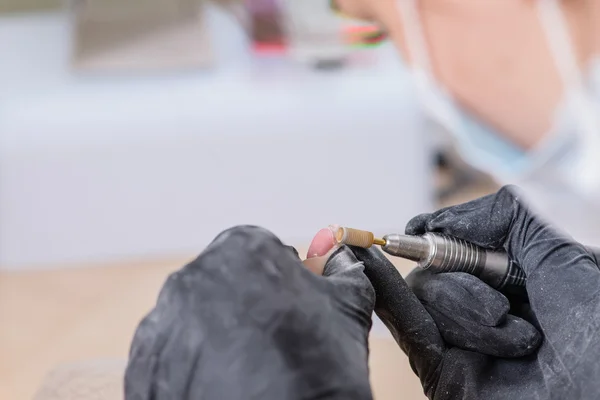 Filing nail manicure drill with paddle, close-up, focus on the i — Stock Photo, Image