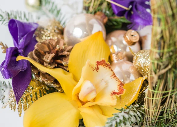 Close-up of Christmas basket with yellow Cymbidium orchid flower