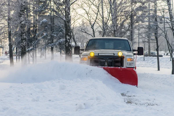 car pickup cleaned from snow by a snowplough during wintertime