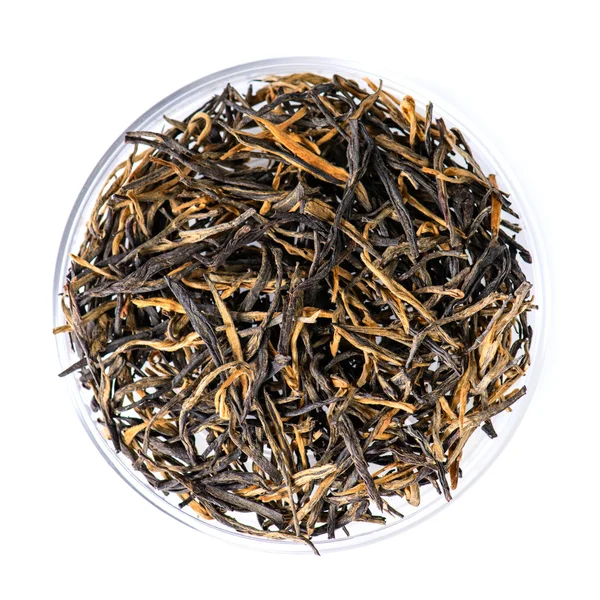 Close-up of spilled tea Golden needle with a red-haired (Golden — Zdjęcie stockowe