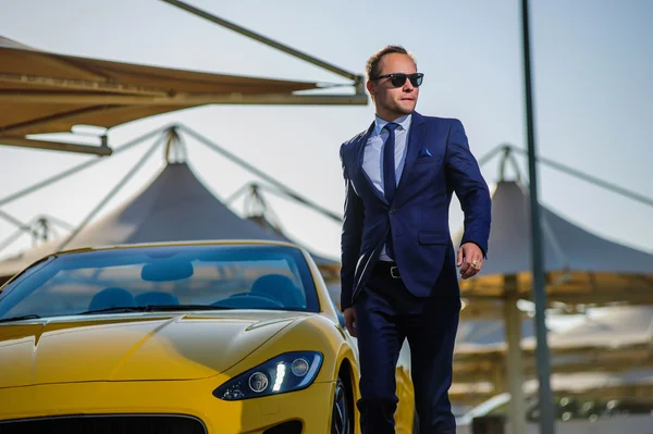 Successful yang businessman in yellow cabrio car — Stock Photo, Image