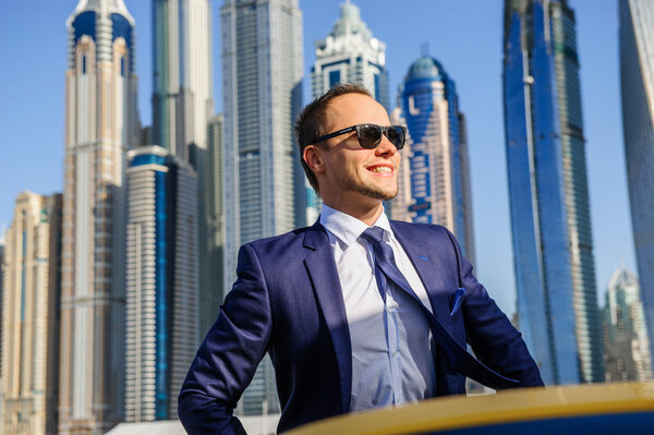 Successful yang businessman in yellow cabrio car