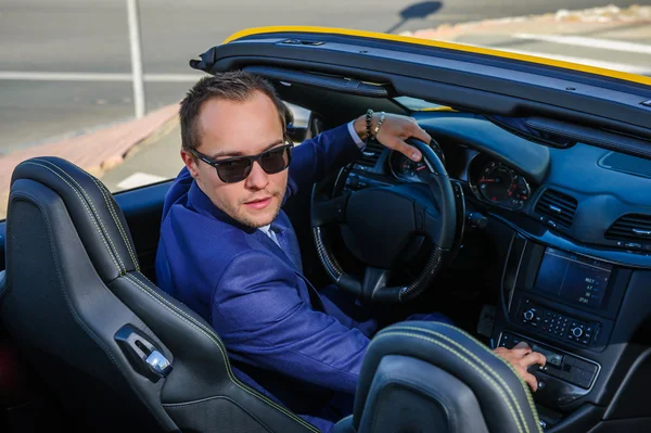 Successful yang businessman in yellow cabrio car. — Stock Photo, Image