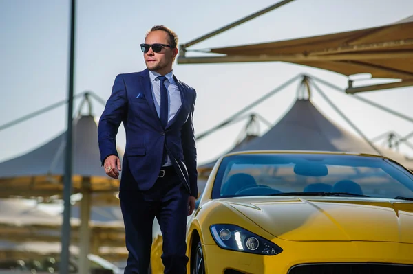 Successful yang businessman in yellow cabrio car. — Stock Photo, Image