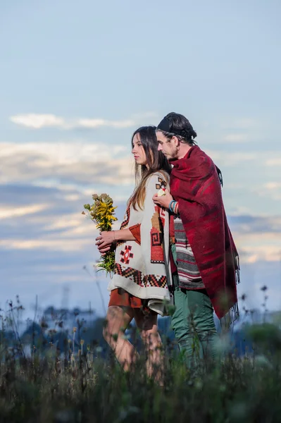 Hippie way dressed couple pose in the morning sky background — Stock Photo, Image