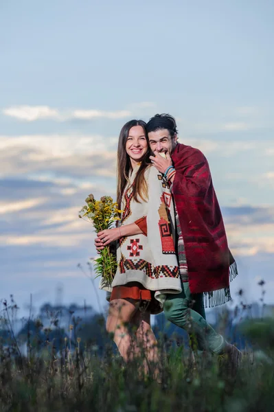 Hippie way dressed couple pose in the morning sky background — Stock Photo, Image