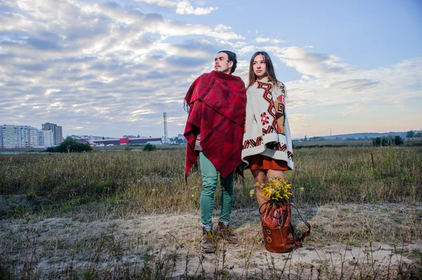 Hippie way dressed couple pose in the morning sky background — Stock Photo, Image