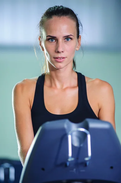 Young woman runs on a treadmill, is engaged in fitness sport club — Stock Photo, Image